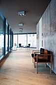 Hall in modern apartment with wooden floor and empty chairs