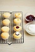 Cupcakes with jam on a wire rack