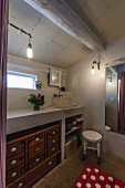 Chest of drawers below masonry washstand in bathroom