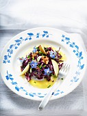 Red cabbage salad with apple and borage flowers
