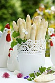 White asparagus in a flower pots on a table laid for Easter in the garden