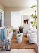 White sofa and rattan armchairs in loggia