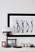 Framed photo on wall above Art Deco, vintage table lamp