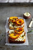 Slices of toast topped with roasted peaches and vanilla mascarpone cream