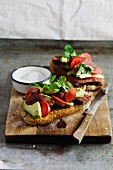Grilled bread topped with steak, marinated radish and avocado