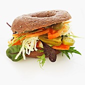 A wholemeal bagel with vegetables and jalapeños
