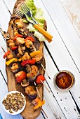 Grilled skewers with vegetables and mushrooms on a wooden board