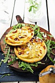Vegetable pizza with feta cheese and rocket