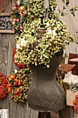 Tailors' dummy with wreath of hops on autumn market