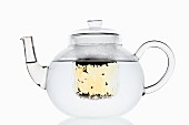 Water in a glass teapot with a filter