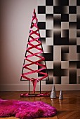 Modern Christmas tree made from metal frame with pink silk ribbon