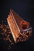 A slice of truffle cake with chocolate curls