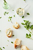 Homemade herb butter and slices of baguette
