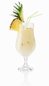 A Pina Colada garnished with fresh pineapple