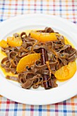 Chocolate pasta in orange sauce