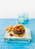A burger with avocado and tomatoes