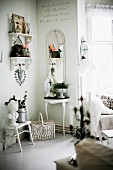 White, carved bracket shelves in corner and various small items of furniture against wall