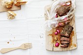 Lamb with a radish medley being removed from a roasting bag