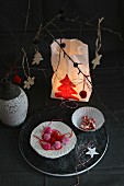 Festive table arrangement and candle lantern made from painted paper bag