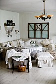 Cosy, rustic lounge area with armchairs, ottomans and corner sofa around coffee table