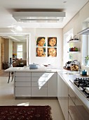 L-shaped kitchen counter with white base -unit fronts and open sliding door to one side