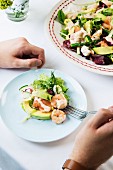 A colourful salad with prawns and avocado