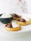 Puff pastry pear tartlets with chocolate sauce and cream