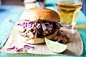 A pulled pork slider with red cabbage and apple