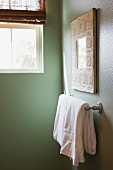 Detail of white towel on rail in bathroom