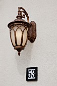 Detail shot of wall lantern and door number at Irvine; California; USA