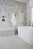 Bathroom with marble walls and bathtub; California; USA