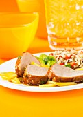 Roast tender loin of pork with glazed apples and rice