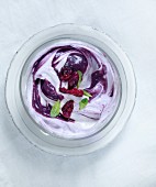 Blueberry yoghurt garnished with mint leaves