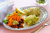 Savoy cabbage parcels filled with minced meat served with a raw carrot salad