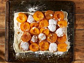 Oven-ready apricot and almond tart dusted with icing sugar