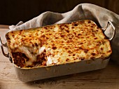 Lasagne in a baking dish, one slice removed