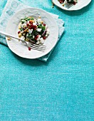 Spinach salad with feta cheese, pomegranate seeds and peanuts