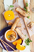 Spring rolls filled with vegetables and prawns and persimmon and ginger dip