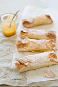 Pastéis de Tentugal (pudding-filled pastry rolls, Portugal) on parchment paper