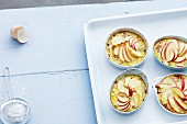 Rice pudding with dates and oranges topped with sliced apple