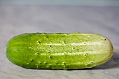 A gherkin on a marble surface