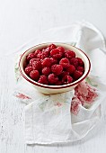 Raspberries in an enamel bowl