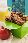 Homemade muesli bars to take away with an apple and a cup of milk