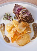 Beef fillet with chorizo with a herb crust served with homemade potato crisps