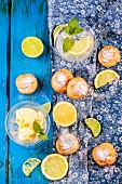 Homemade profiteroles served with lemonade and ice cream on blue wooden table