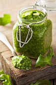Rocket pesto in a jar and on a spoon