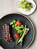 Beef steak with grilled asparagus and potato salad