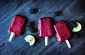 Blackberry and lime ice lollies on a slate platter
