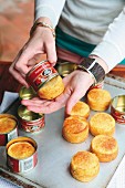 Corn bread being removed from a jar