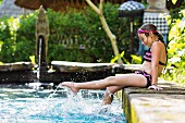 Girl splashing in swimming pool